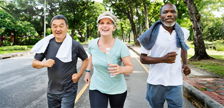 diverse seniors exercising in park for health