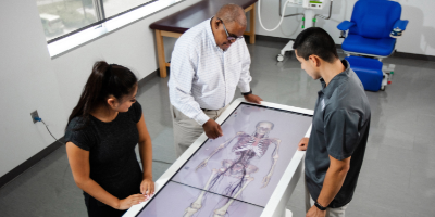 man teaching two college students, dexa scan