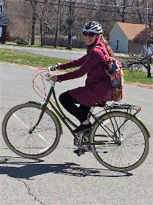 woman riding bike to yoga class
