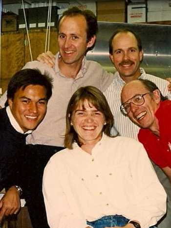 group of five people smiling at the camera