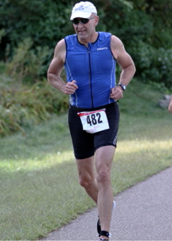 man in a blue shirt running in a race